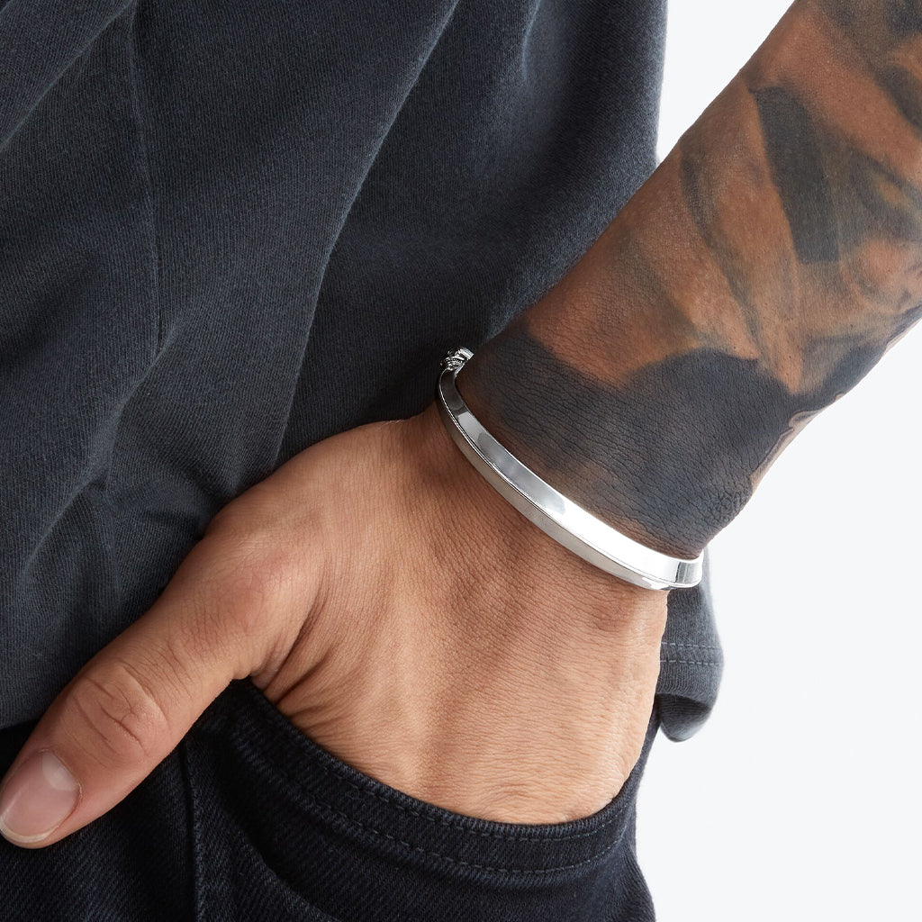 Cuff armband av polerat sterlingsilver med dödskallar i ändarna