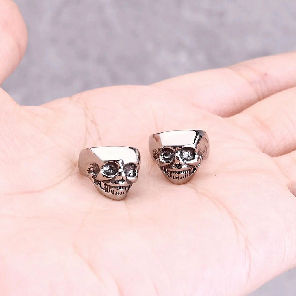 Silverfärgade öronsmycken som är formade som kranium
