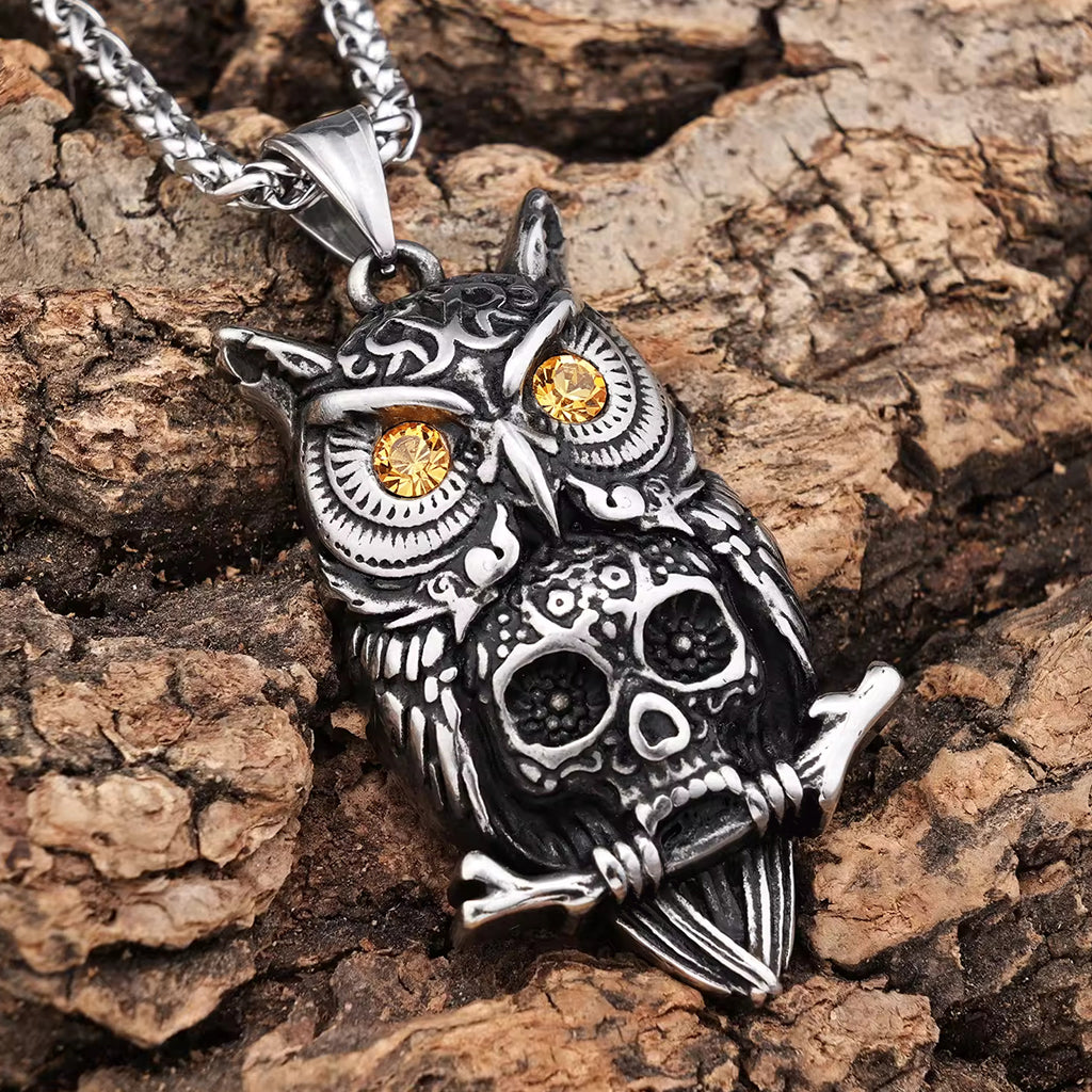 Silverfärgat hängsmycke föreställande en berguv och en dödskalle