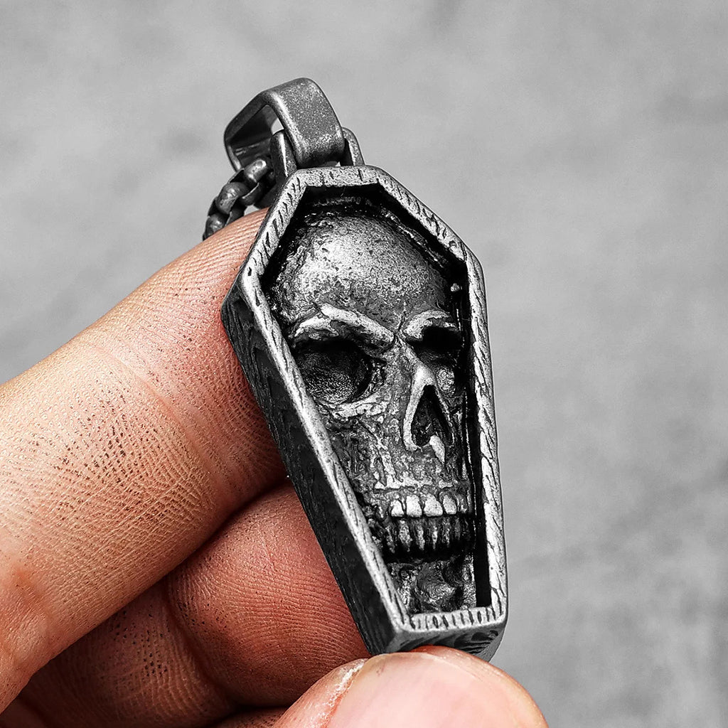 Svärtat hängsmycke föreställande en kista med en dödskalle