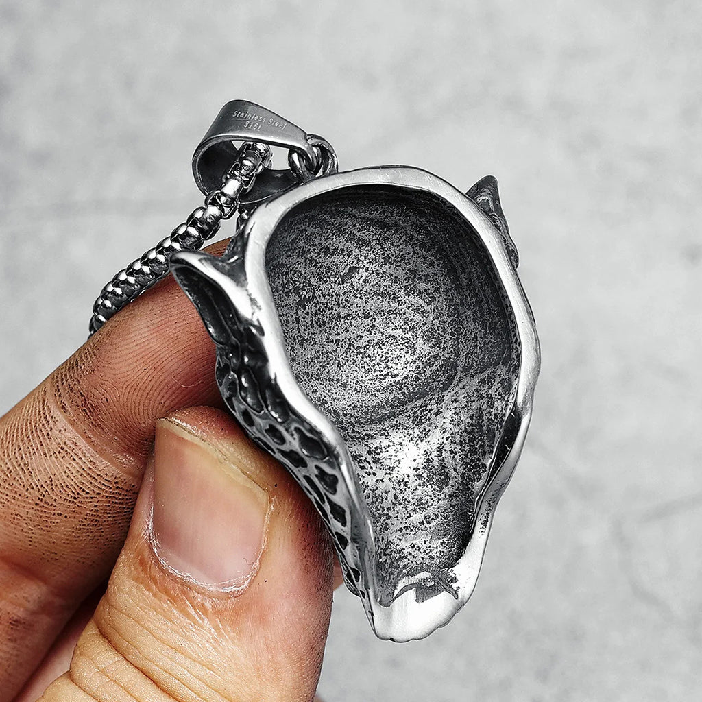 Stålfärgat hängsmycke föreställande ett leopardhuvud med en dödskalle innanför käkarna