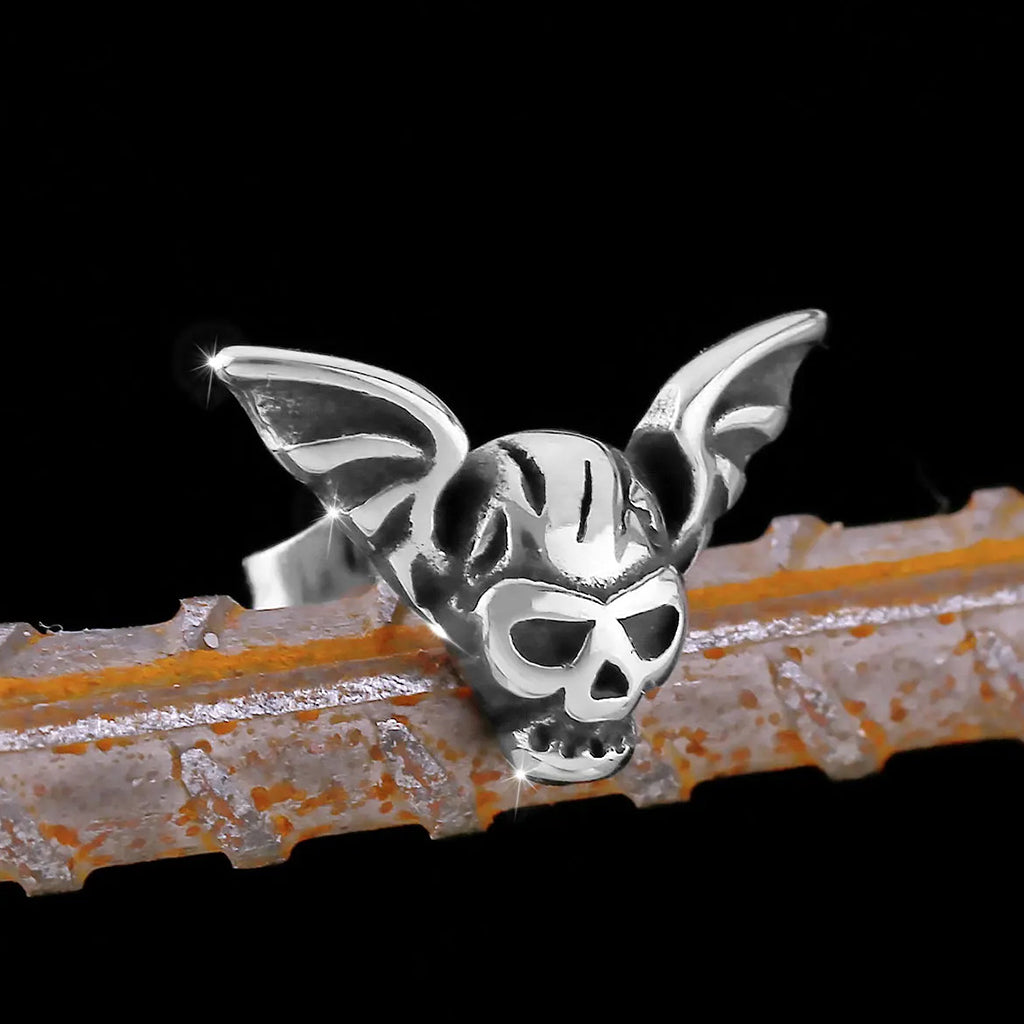 Silverfärgade studs örhängen föreställande en dödskalle och en fladdermus