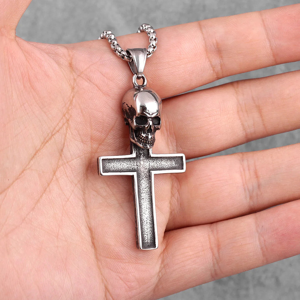 Silverfärgat halsband föreställande ett latinskt kors med en dödskalle upptill