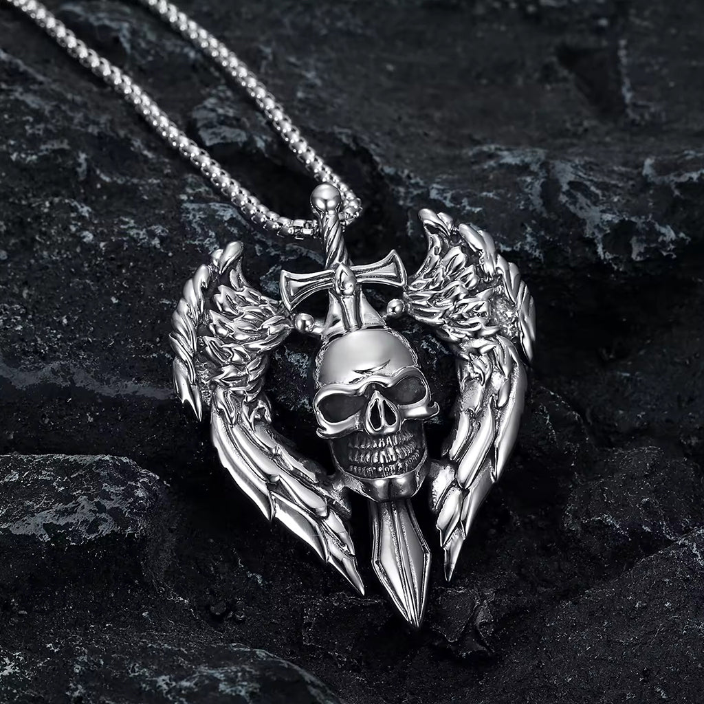 Silverfärgat smycke föreställande en dödskalle och ett svärd med änglavingar