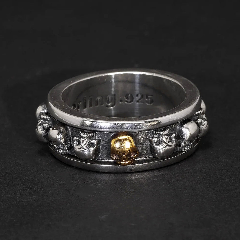 Vridbar spinner ring i sterling silver med dödskallar runtom